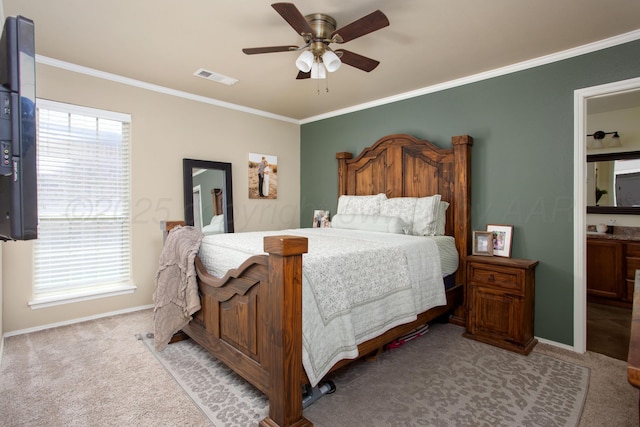 carpeted bedroom featuring crown molding, baseboards, visible vents, and multiple windows