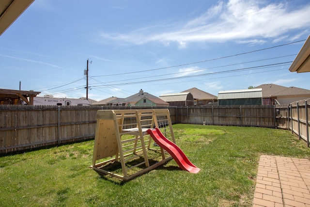 exterior space featuring a fenced backyard and a playground