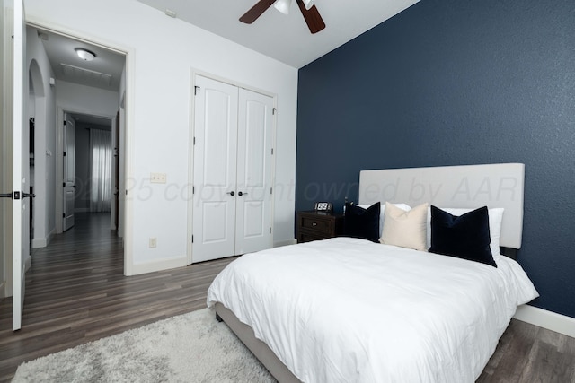 8603 Garden Way Dr, Amarillo, TX 79119 - bedroom featuring baseboards, wood finished floors, a closet, and a ceiling fan