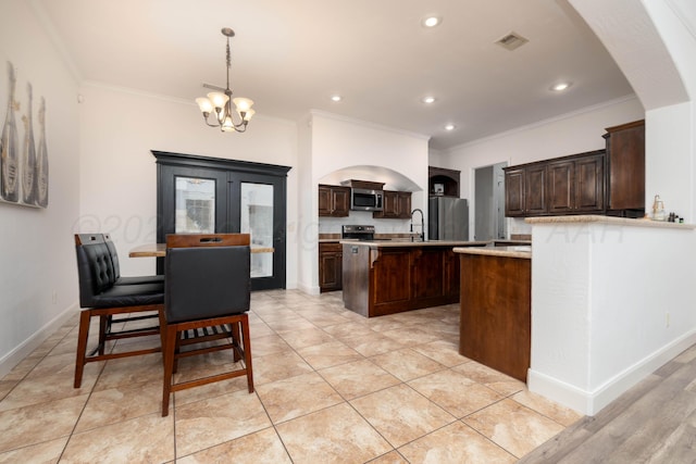 8603 Garden Way Dr, Amarillo, TX 79119 - kitchen with stainless steel appliances, ornamental molding, a center island with sink, a chandelier, and dark brown cabinetry
