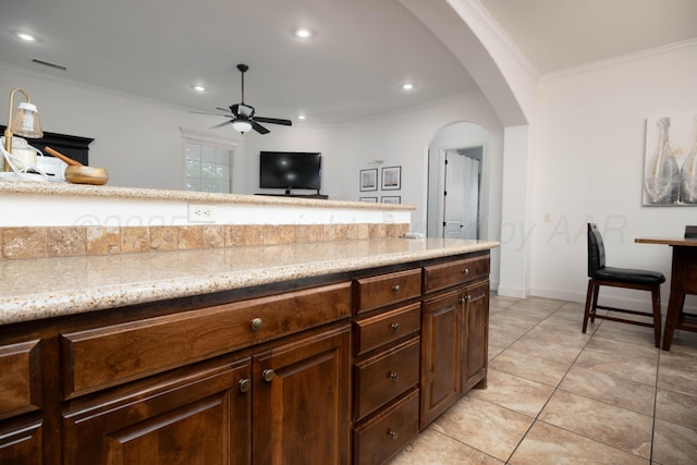 8603 Garden Way Dr, Amarillo, TX 79119 - kitchen with arched walkways, a ceiling fan, ornamental molding, recessed lighting, and light tile patterned floors