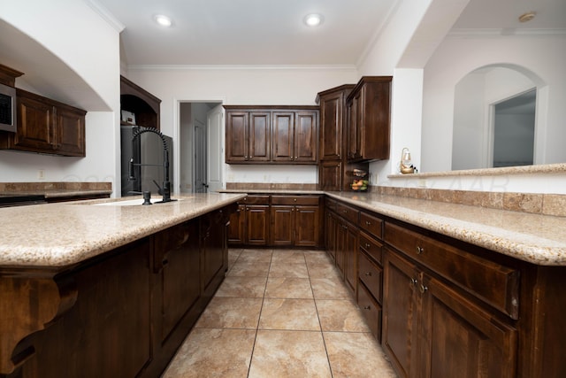 8603 Garden Way Dr, Amarillo, TX 79119 - kitchen featuring a sink, dark brown cabinetry, crown molding, recessed lighting, and light stone counters
