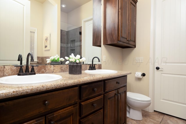 8603 Garden Way Dr, Amarillo, TX 79119 - full bathroom featuring double vanity, a tile shower, toilet, and tile patterned floors