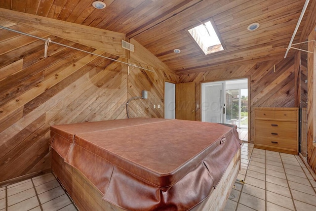 145 N Kingwood St, Hereford, TX 79045 - bedroom featuring light tile patterned floors, wooden ceiling, wood walls, and lofted ceiling with skylight