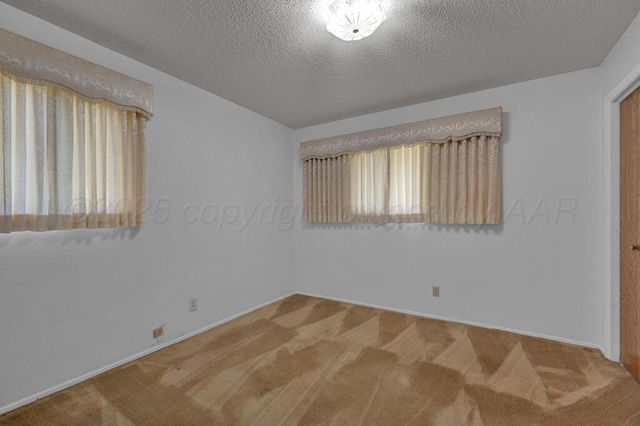 145 N Kingwood St, Hereford, TX 79045 - empty room with baseboards, carpet flooring, and a textured ceiling
