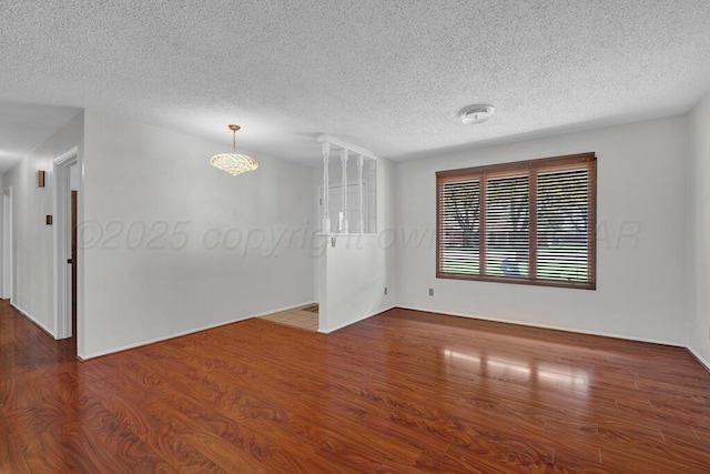 145 N Kingwood St, Hereford, TX 79045 - unfurnished room featuring a textured ceiling and wood finished floors