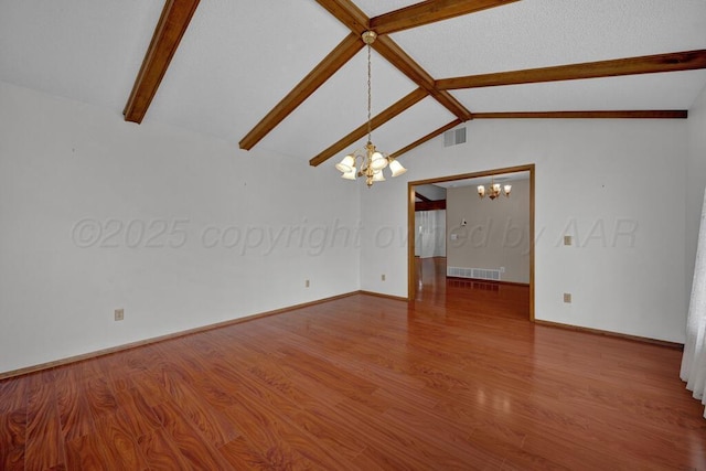 145 N Kingwood St, Hereford, TX 79045 - spare room featuring visible vents, wood finished floors, baseboards, lofted ceiling with beams, and an inviting chandelier