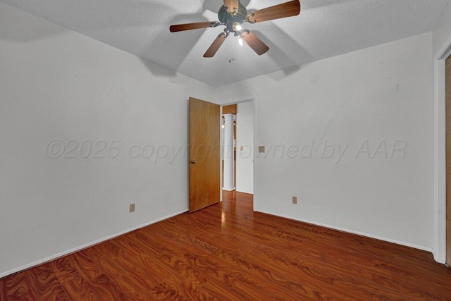 145 N Kingwood St, Hereford, TX 79045 - spare room with a textured ceiling, baseboards, a ceiling fan, and wood finished floors