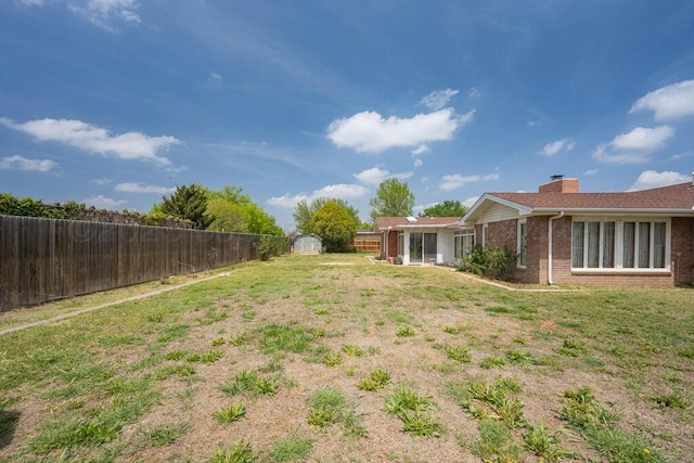145 N Kingwood St, Hereford, TX 79045 - view of yard with a fenced backyard, an outdoor structure, and a shed