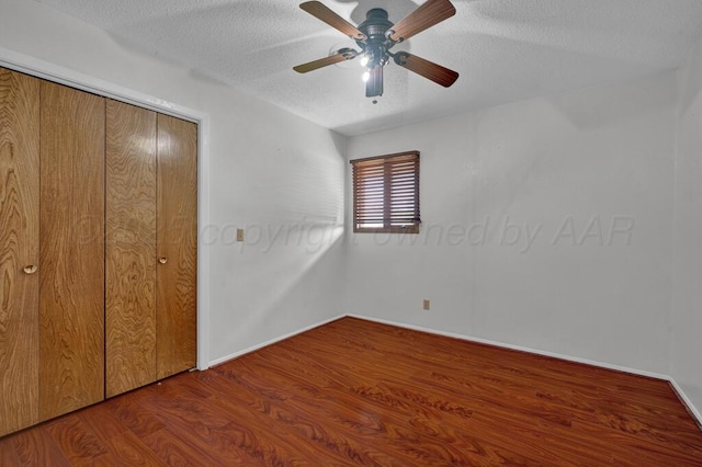 145 N Kingwood St, Hereford, TX 79045 - unfurnished bedroom featuring ceiling fan, a textured ceiling, baseboards, wood finished floors, and a closet