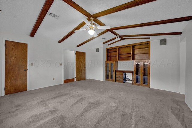 145 N Kingwood St, Hereford, TX 79045 - unfurnished living room featuring vaulted ceiling with beams, a ceiling fan, carpet flooring, and visible vents