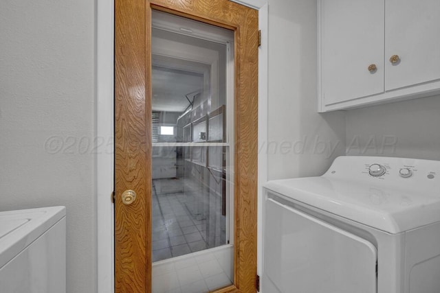 145 N Kingwood St, Hereford, TX 79045 - laundry area with cabinet space and washing machine and clothes dryer