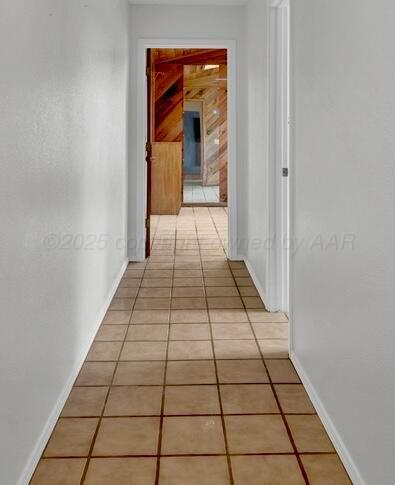 145 N Kingwood St, Hereford, TX 79045 - corridor with baseboards and light tile patterned flooring