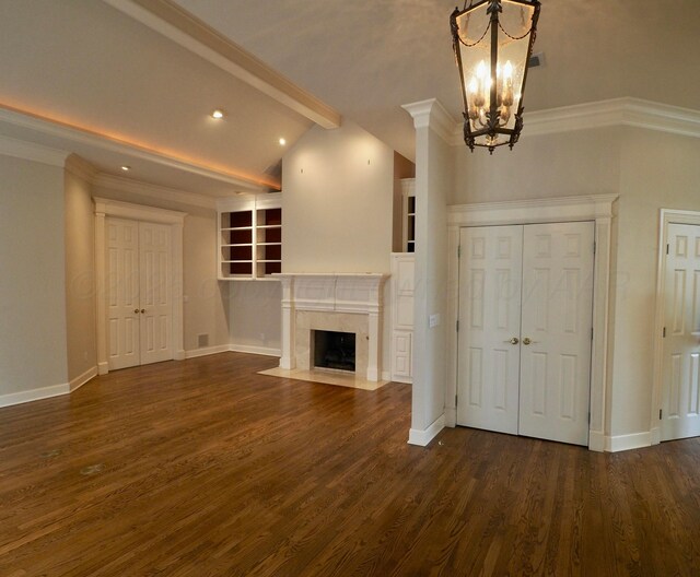 5105 Olsen Cir, Amarillo, TX 79106 - unfurnished living room with a chandelier, dark wood-style flooring, a premium fireplace, recessed lighting, and built in shelves