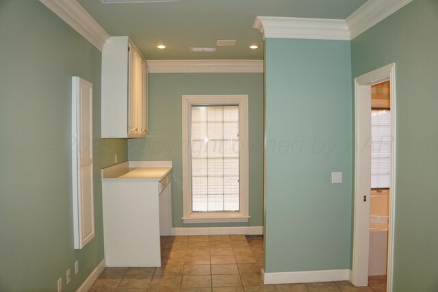 5105 Olsen Cir, Amarillo, TX 79106 - kitchen featuring crown molding, light countertops, white cabinetry, recessed lighting, and light tile patterned floors