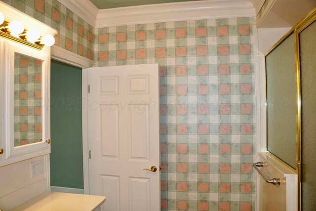 5105 Olsen Cir, Amarillo, TX 79106 - bathroom featuring vanity, crown molding, and a shower with door