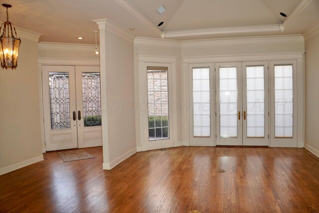5105 Olsen Cir, Amarillo, TX 79106 - foyer entrance with french doors, lofted ceiling, wood finished floors, ornamental molding, and a chandelier