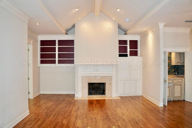 5105 Olsen Cir, Amarillo, TX 79106 - unfurnished living room featuring wood finished floors, a fireplace, ornamental molding, built in shelves, and recessed lighting