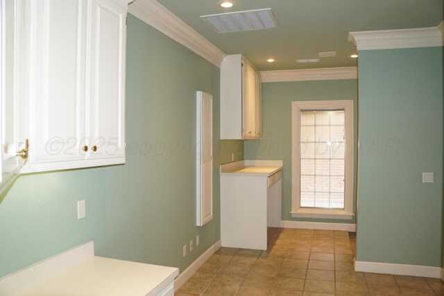 5105 Olsen Cir, Amarillo, TX 79106 - kitchen with ornamental molding, light countertops, recessed lighting, white cabinetry, and light tile patterned flooring