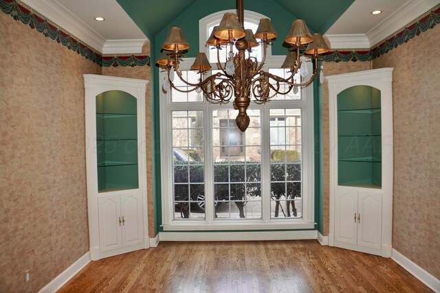 5105 Olsen Cir, Amarillo, TX 79106 - unfurnished dining area with a chandelier, ornamental molding, wallpapered walls, wood finished floors, and vaulted ceiling