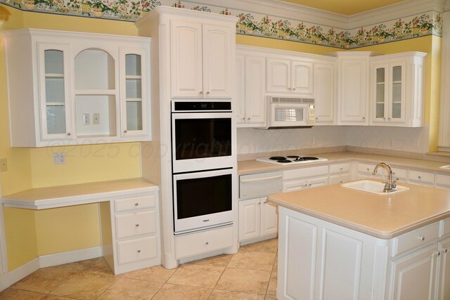 5105 Olsen Cir, Amarillo, TX 79106 - kitchen featuring white appliances, a warming drawer, light countertops, glass insert cabinets, and white cabinets