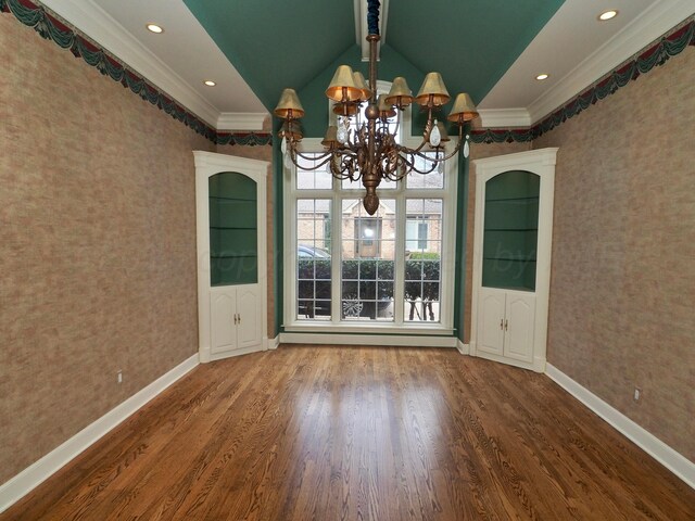 5105 Olsen Cir, Amarillo, TX 79106 - unfurnished dining area with a chandelier, wallpapered walls, crown molding, wood finished floors, and vaulted ceiling