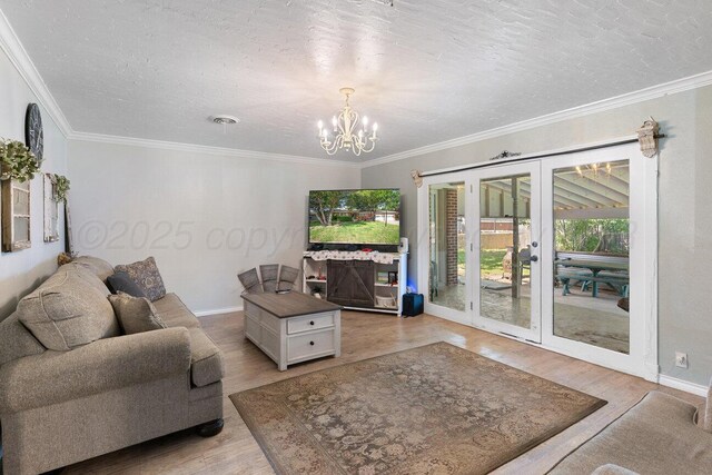 2209 N Beech Ln, Pampa, TX 79065 - living room with light wood-style floors, a chandelier, french doors, baseboards, and a textured ceiling