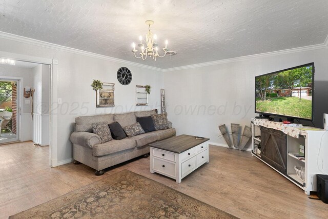 2209 N Beech Ln, Pampa, TX 79065 - living room featuring a chandelier, light wood-style floors, baseboards, ornamental molding, and a textured ceiling