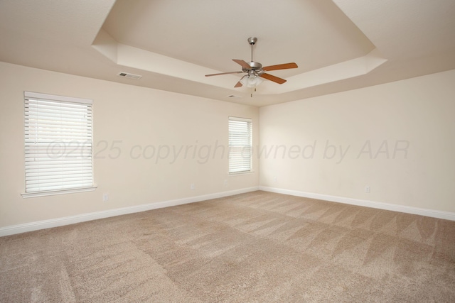 7308 Sinclair St, Amarillo, TX 79119 - empty room featuring a tray ceiling, a ceiling fan, and carpet floors