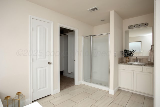 7308 Sinclair St, Amarillo, TX 79119 - full bath with a stall shower, vanity, and a spacious closet