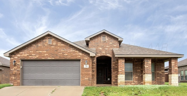 7308 Sinclair St, Amarillo, TX 79119 - view of front of home featuring brick siding, a shingled roof, driveway, and an attached garage