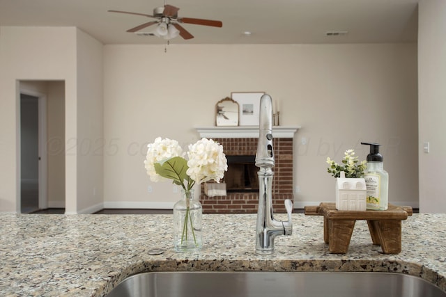 7308 Sinclair St, Amarillo, TX 79119 - detailed view of a ceiling fan, light stone countertops, and a fireplace