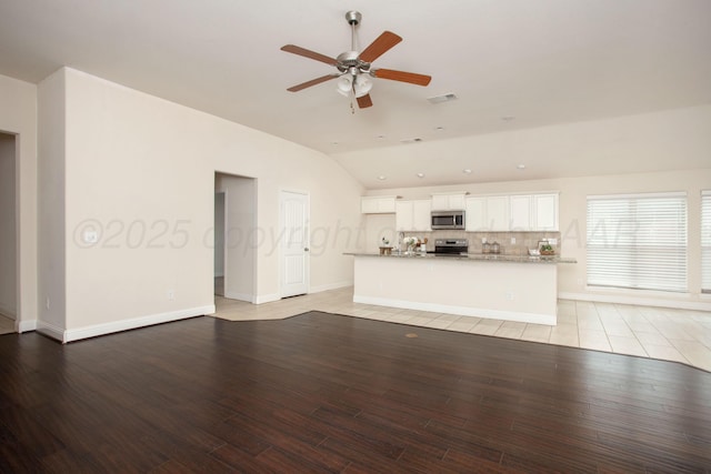 7308 Sinclair St, Amarillo, TX 79119 - unfurnished living room featuring lofted ceiling, a ceiling fan, and light wood finished floors