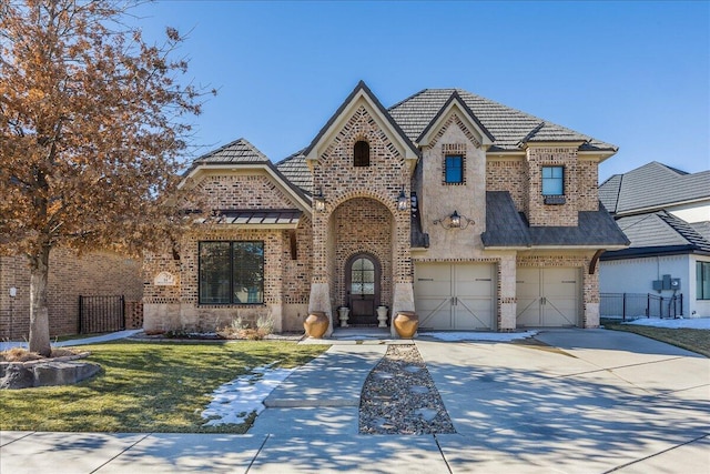 view of front facade with a garage and a front yard