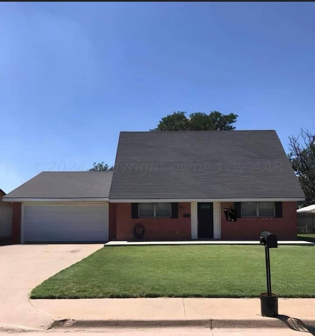 605 Star St, Hereford, TX 79045 - new england style home featuring a garage, concrete driveway, a fenced front yard, and brick siding