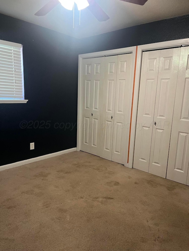 605 Star St, Hereford, TX 79045 - unfurnished bedroom with multiple closets, light carpet, and ceiling fan
