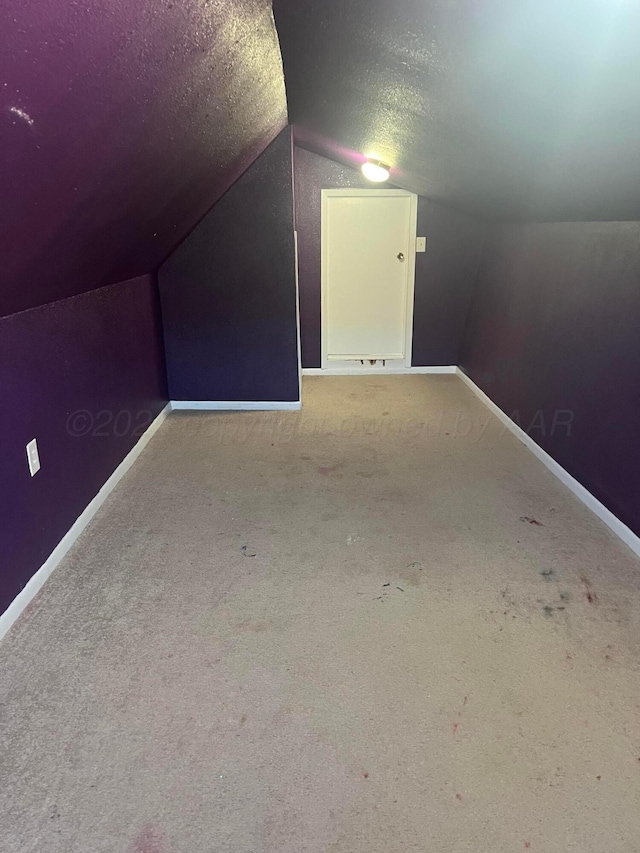 605 Star St, Hereford, TX 79045 - additional living space featuring vaulted ceiling, carpet flooring, and a textured ceiling