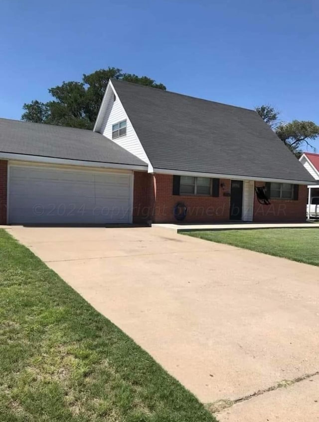 605 Star St, Hereford, TX 79045 - view of front of house featuring concrete driveway, a garage, a front yard, and brick siding