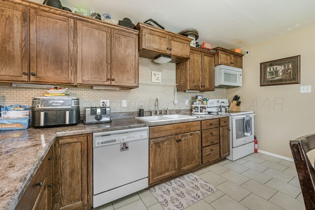 4114 S Hayden St, Amarillo, TX 79119 - kitchen with white appliances, tasteful backsplash, and brown cabinetry