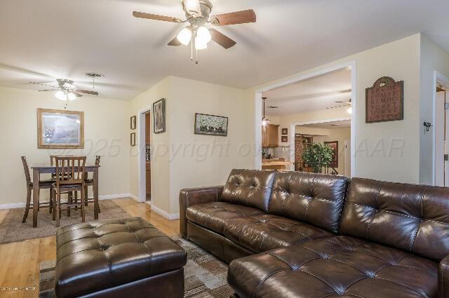 3406 Patterson Dr, Amarillo, TX 79109 - living room with ceiling fan, light wood-style flooring, and baseboards