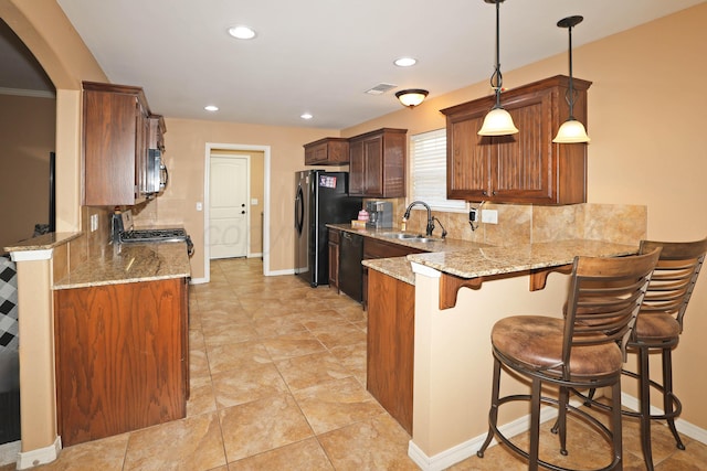 6501 Nancy Ellen St, Amarillo, TX 79119 - kitchen with black appliances, a peninsula, light stone countertops, backsplash, and recessed lighting