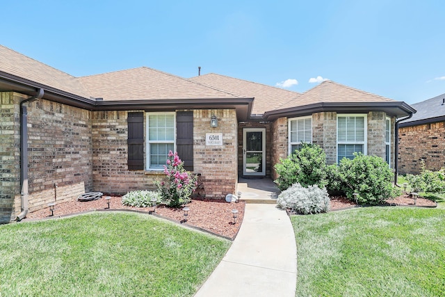 6501 Nancy Ellen St, Amarillo, TX 79119 - single story home featuring brick siding, a front yard, and a shingled roof