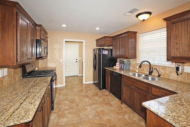 6501 Nancy Ellen St, Amarillo, TX 79119 - kitchen with black appliances, decorative backsplash, light stone countertops, and recessed lighting