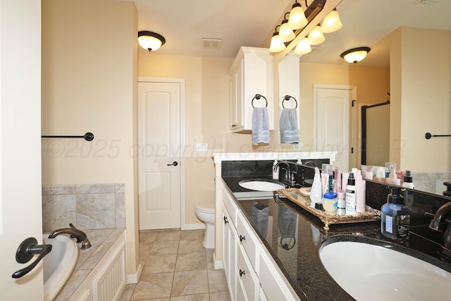 6501 Nancy Ellen St, Amarillo, TX 79119 - bathroom featuring double vanity, a garden tub, a shower stall, and tile patterned flooring