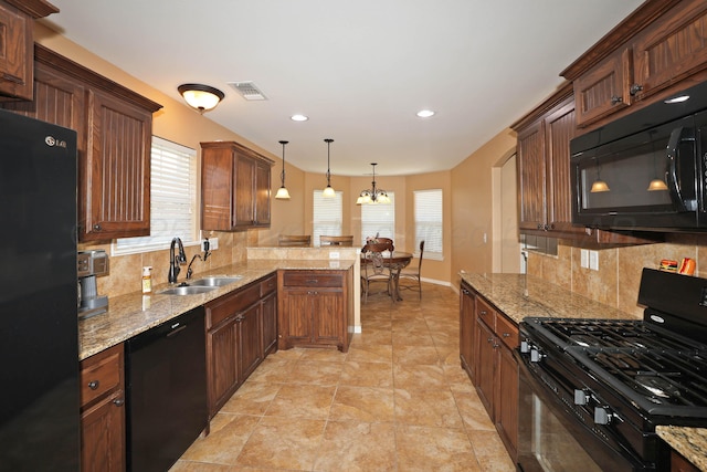 6501 Nancy Ellen St, Amarillo, TX 79119 - kitchen with black appliances, tasteful backsplash, a peninsula, pendant lighting, and light stone countertops