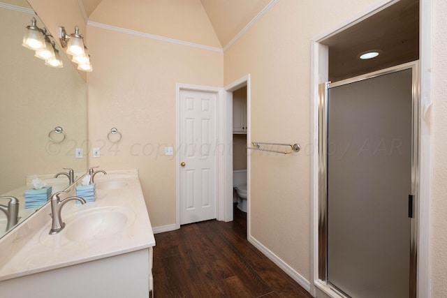 bathroom with vanity, an enclosed shower, vaulted ceiling, hardwood / wood-style flooring, and toilet