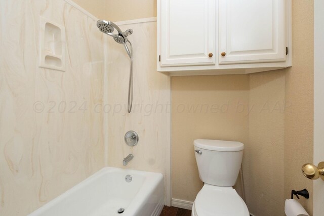 bathroom with washtub / shower combination and toilet