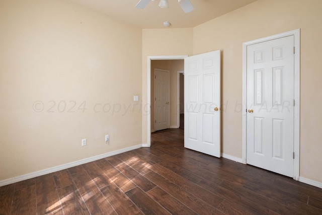 unfurnished bedroom featuring dark wood-type flooring and ceiling fan