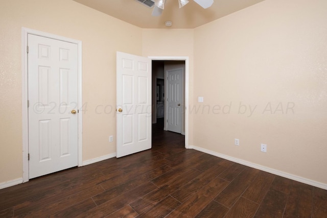 unfurnished bedroom with dark hardwood / wood-style flooring and ceiling fan