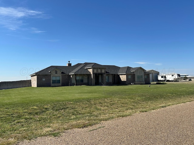 17901 19th St, Amarillo, TX 79124 - view of front facade featuring a front yard, a chimney, and brick siding